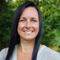 woman standing outside smiling at camera