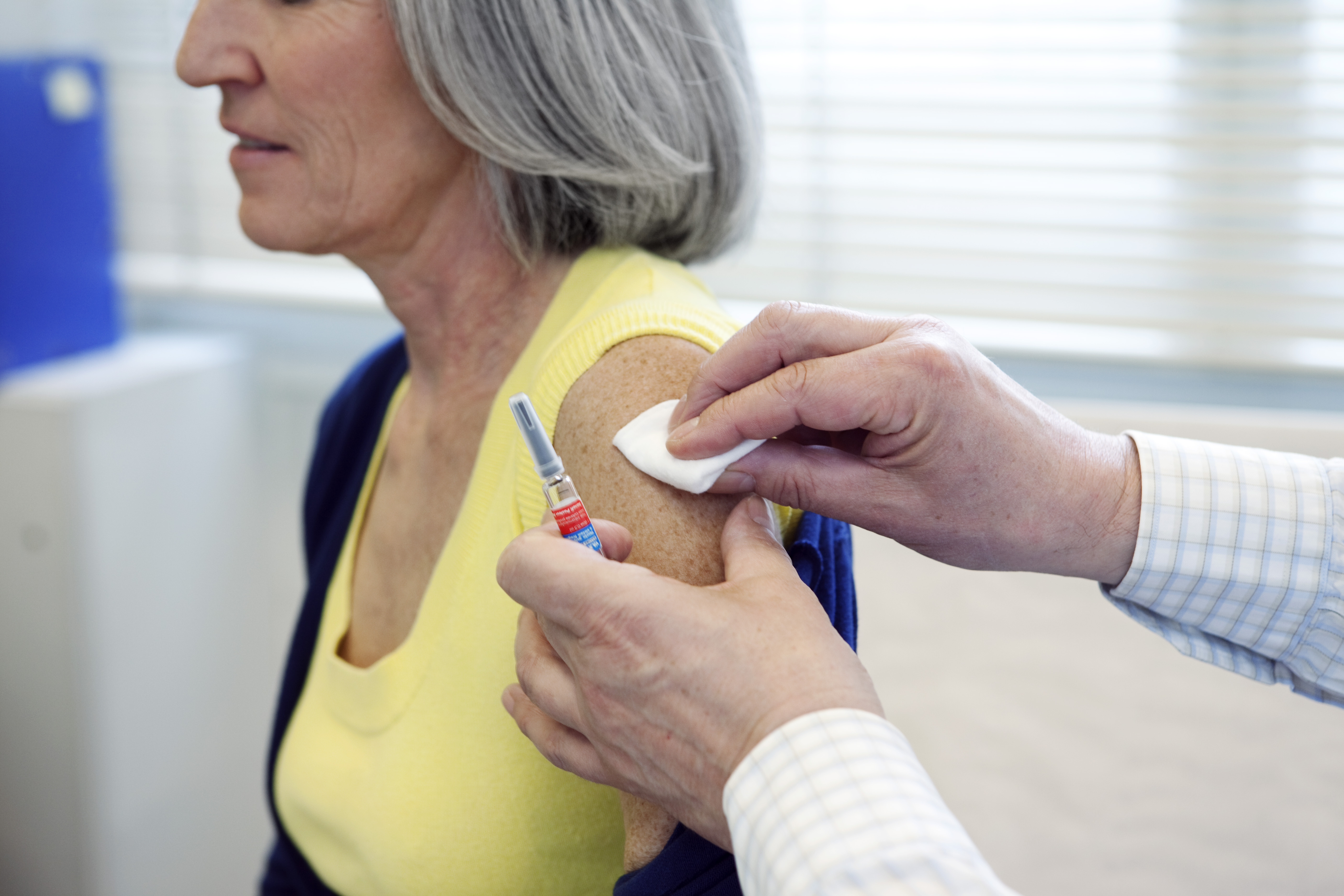 older woman receiving vaccination