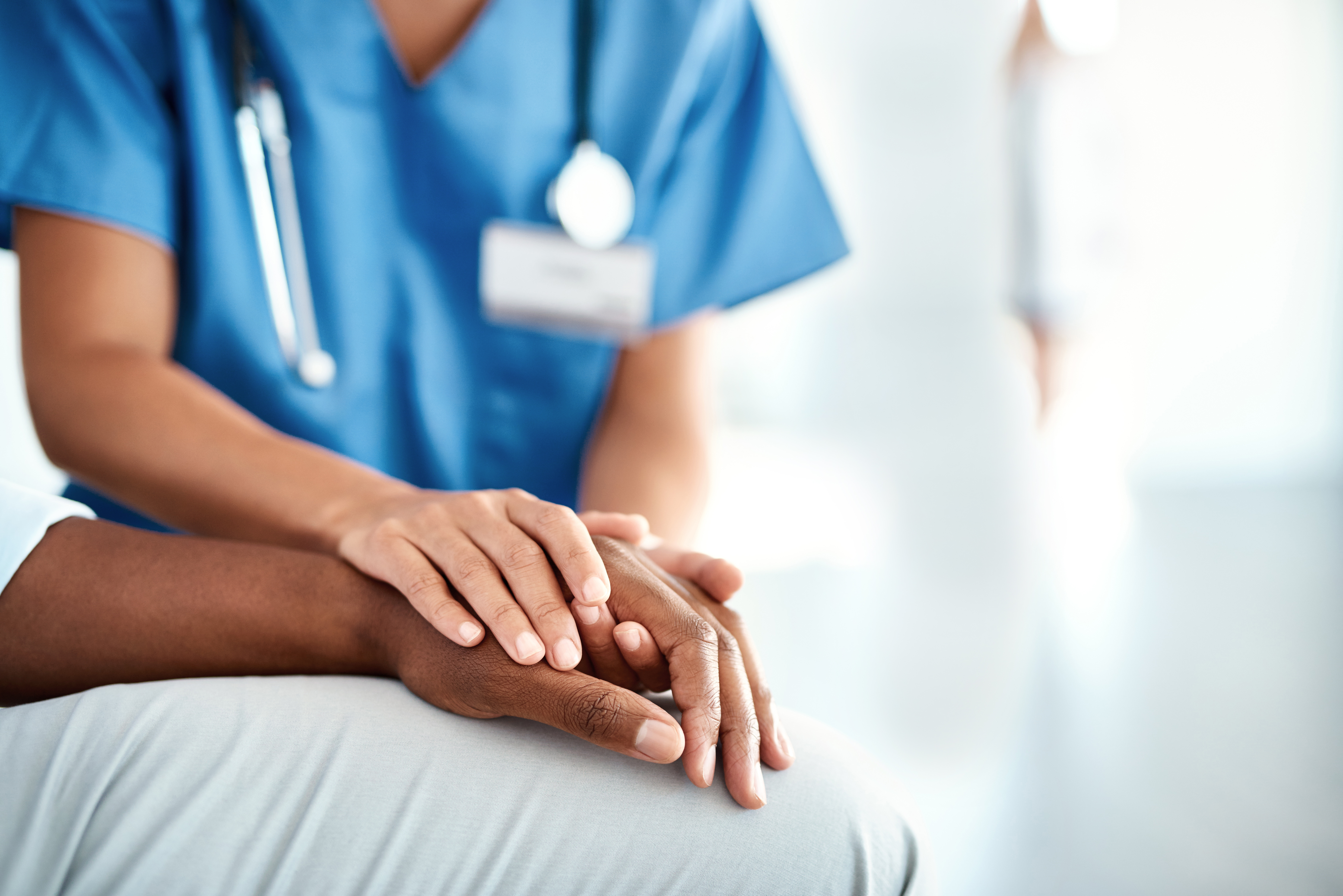 Cropped shot of an unrecognizable female nurse comforting a patient in the hospital