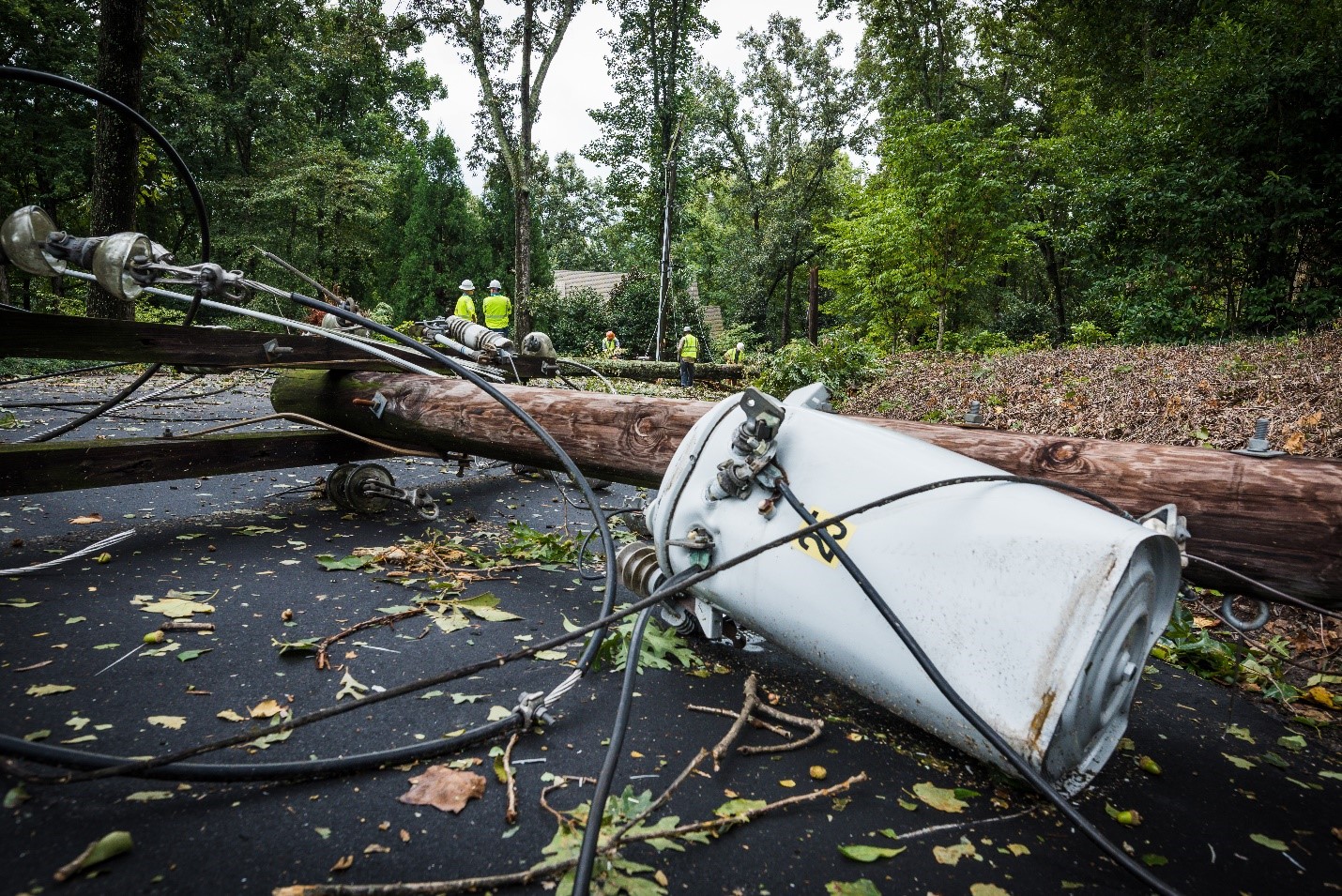 electrical transformer on the ground with wires and a telephone poll