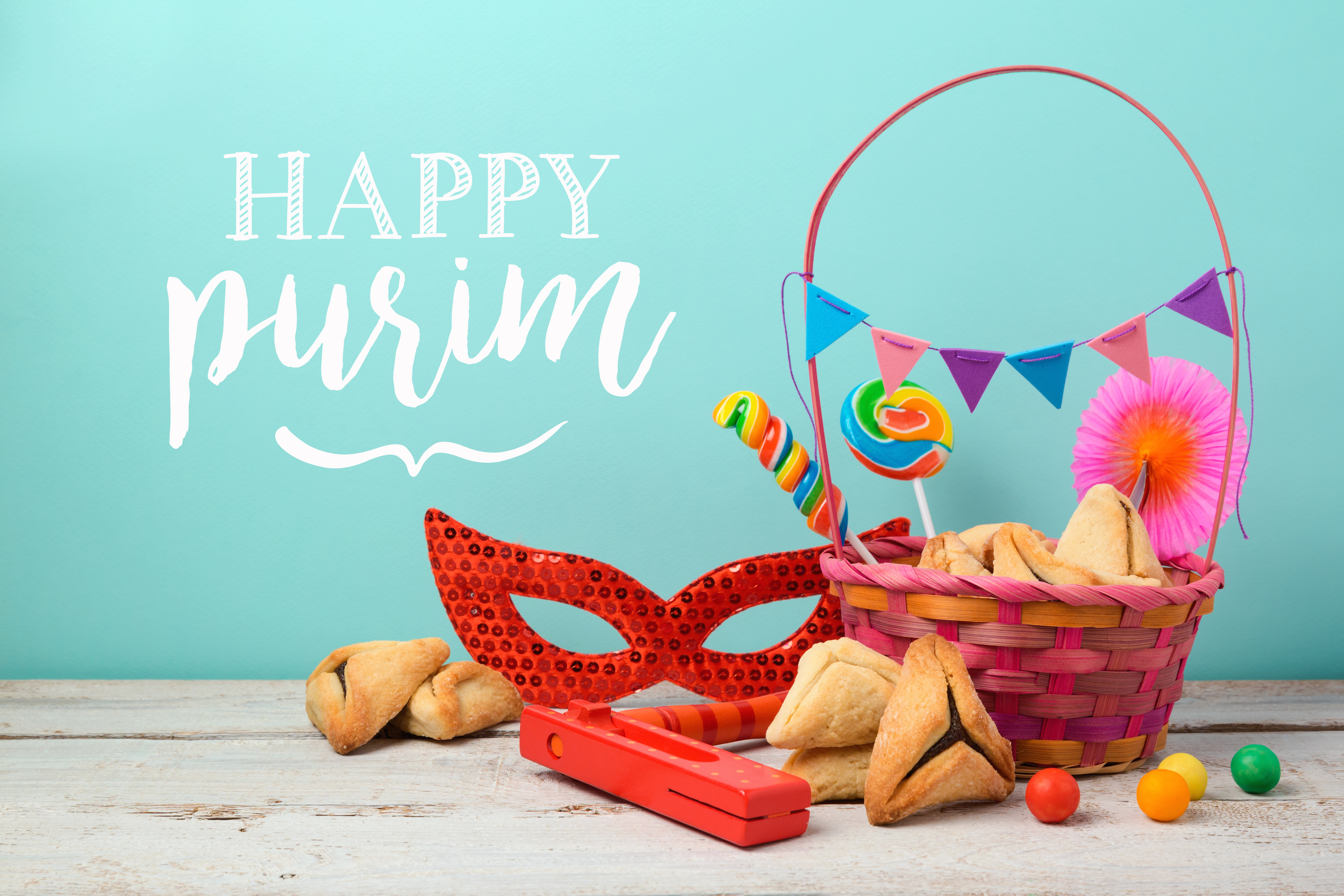 basket filled with treats words stating "happy purim"