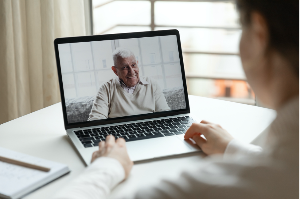 woman speaking with elderly man on webcall